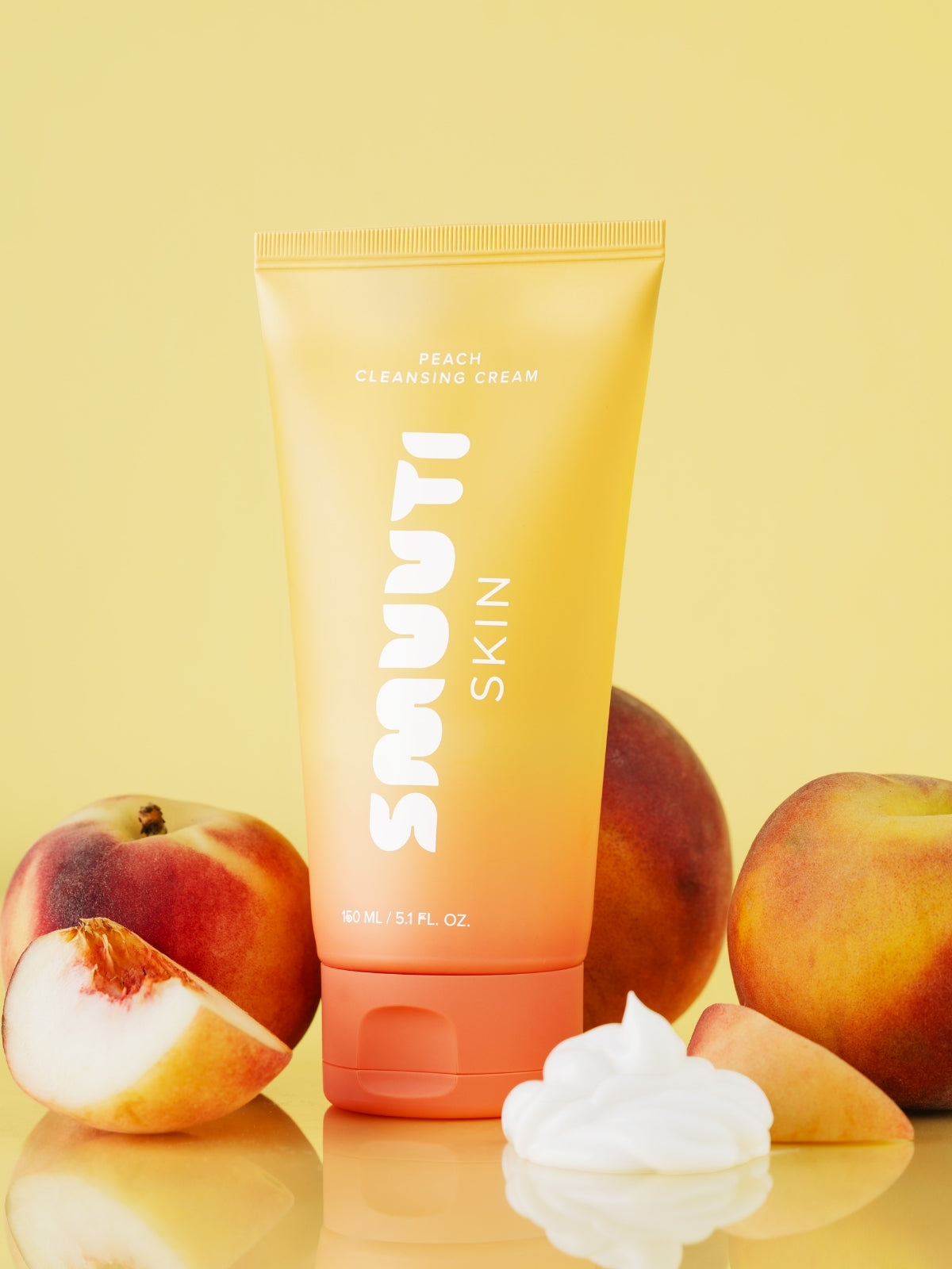 SMUUTI SKIN peach cleansing cream tube with peaches on a yellow background