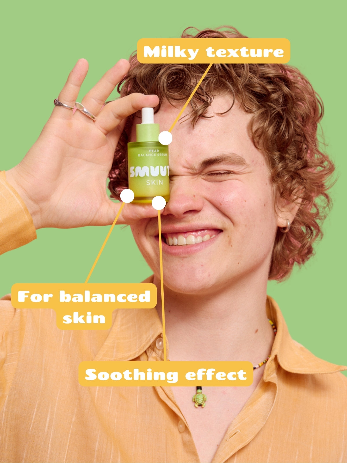 Person holding Smuuti Skin pear balance serum on a green background