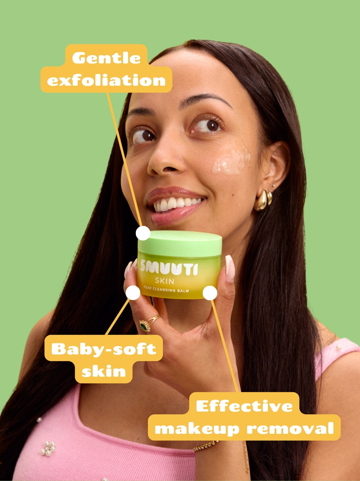 Woman holding Smuuti Skin pear cleansing balm with text on a green background