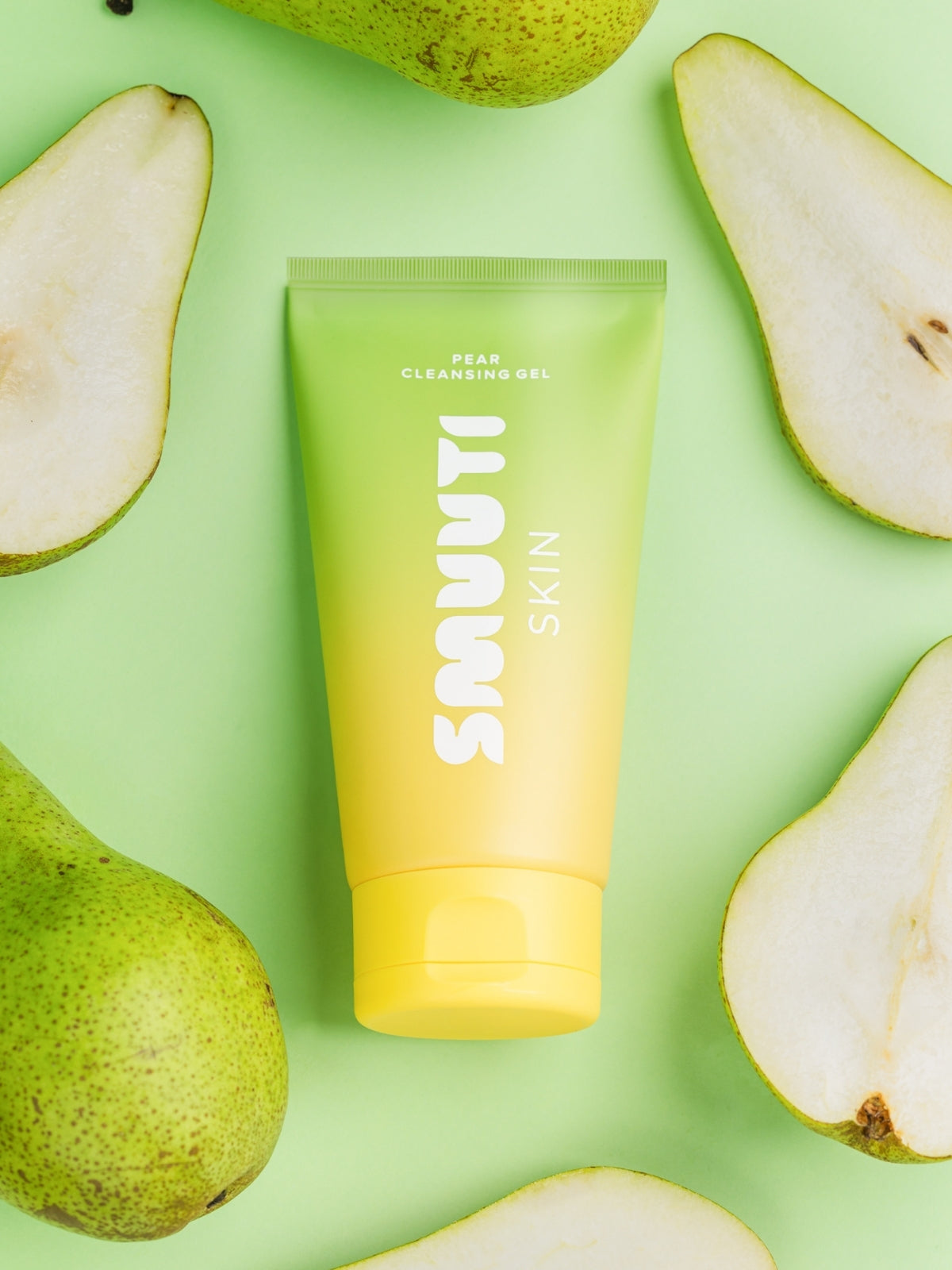 Smuuti Skin pear cleansing gel surrounded by sliced pears on a green background