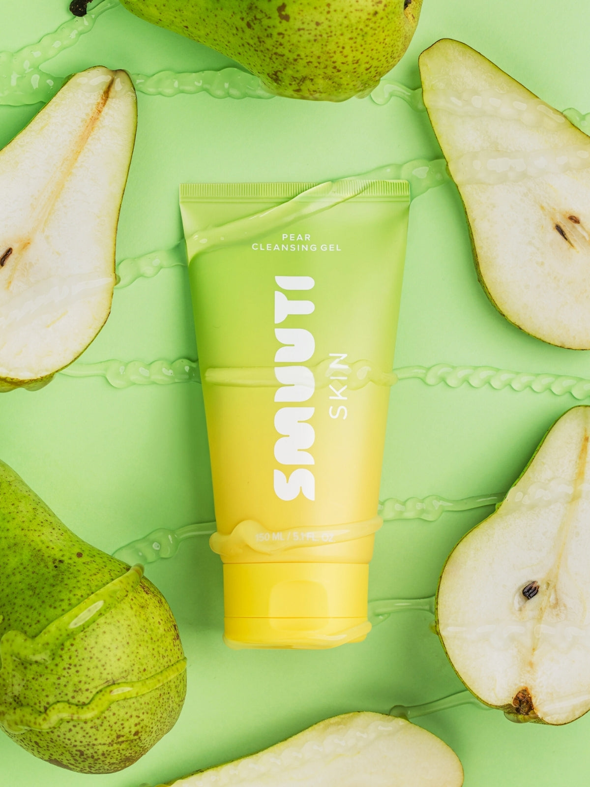 Smuuti Skin pear cleansing gel surrounded by sliced pears on a green background