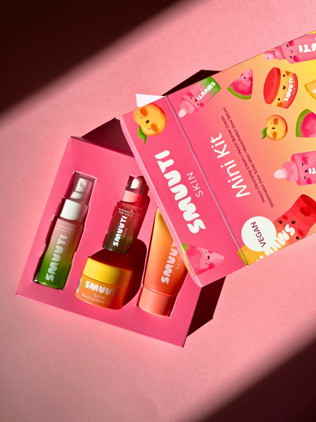 Smuuti Skin mini kit with colorful packaging on a pink background