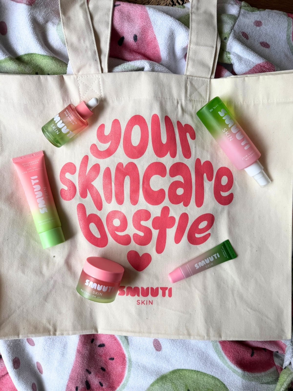 Tote bag with 'your skincare bestie' text and Smuuti Skin skincare products on a watermelon-themed background