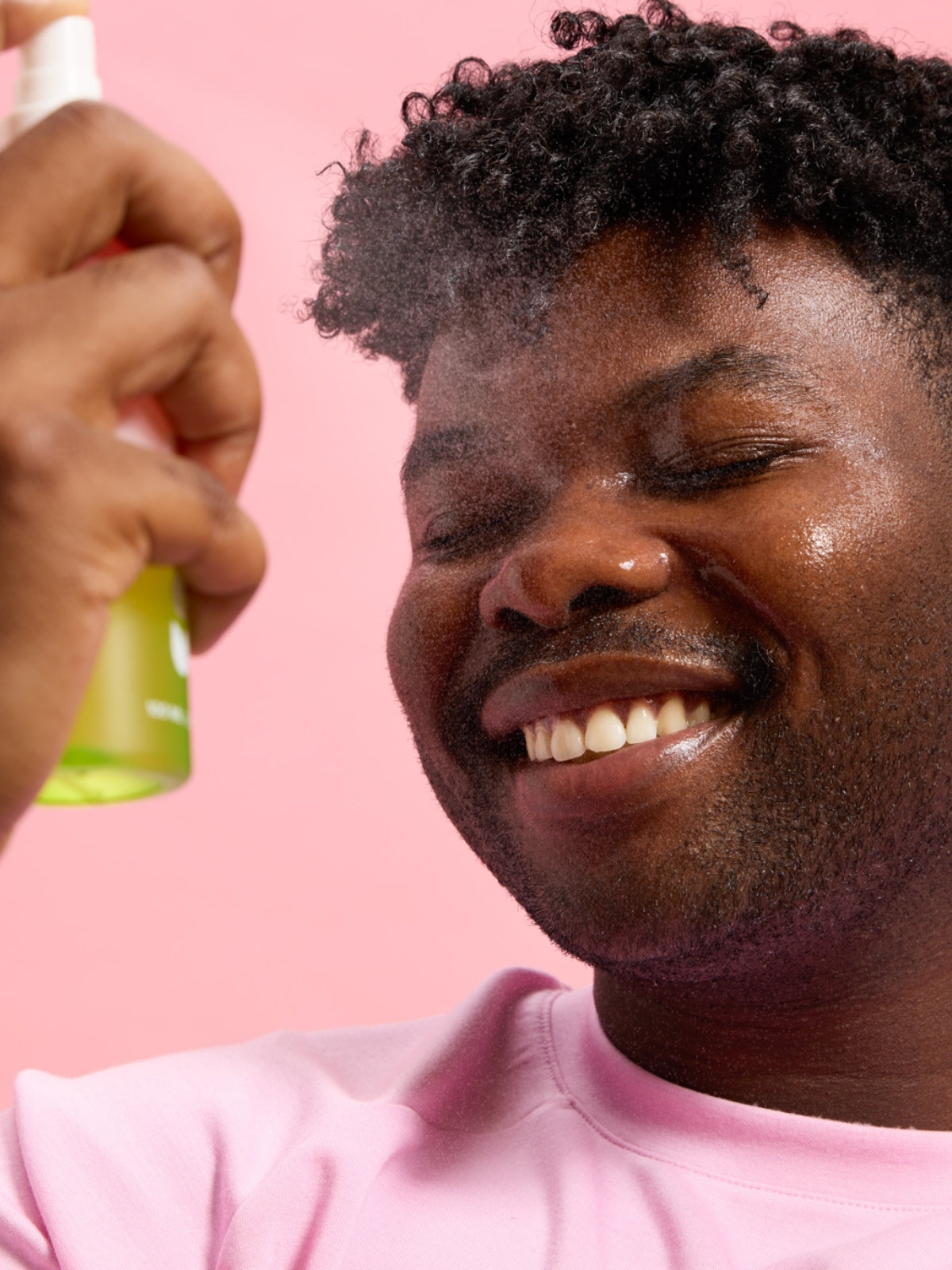 person spraying Smuuti Skin watermelon dew toner mist onto his face