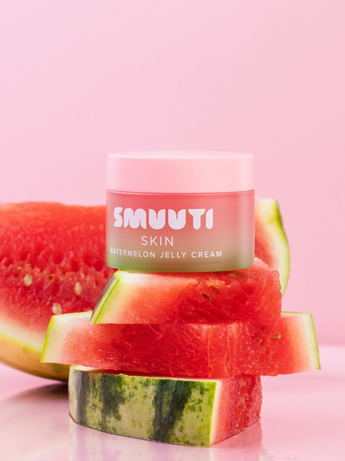 SMUUTI Skin watermelon jelly cream jar surrounded by watermelon slices on a pink background