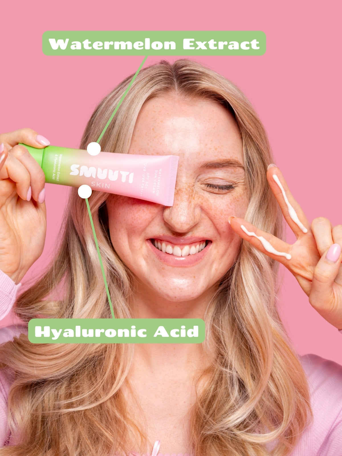 Woman applying Smuuti Skin watermelon sun cream with text 'Watermelon Extract' and 'Hyaluronic Acid' on a pink background
