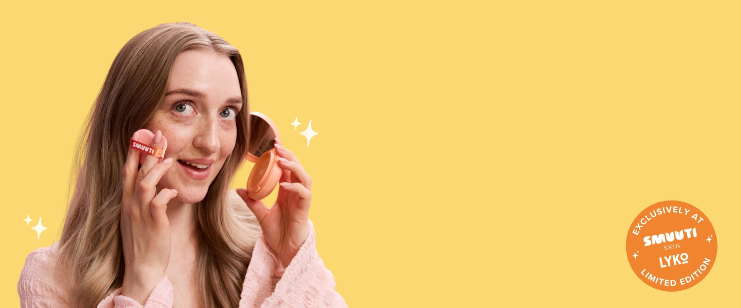 Woman applying sun cream with a yellow background