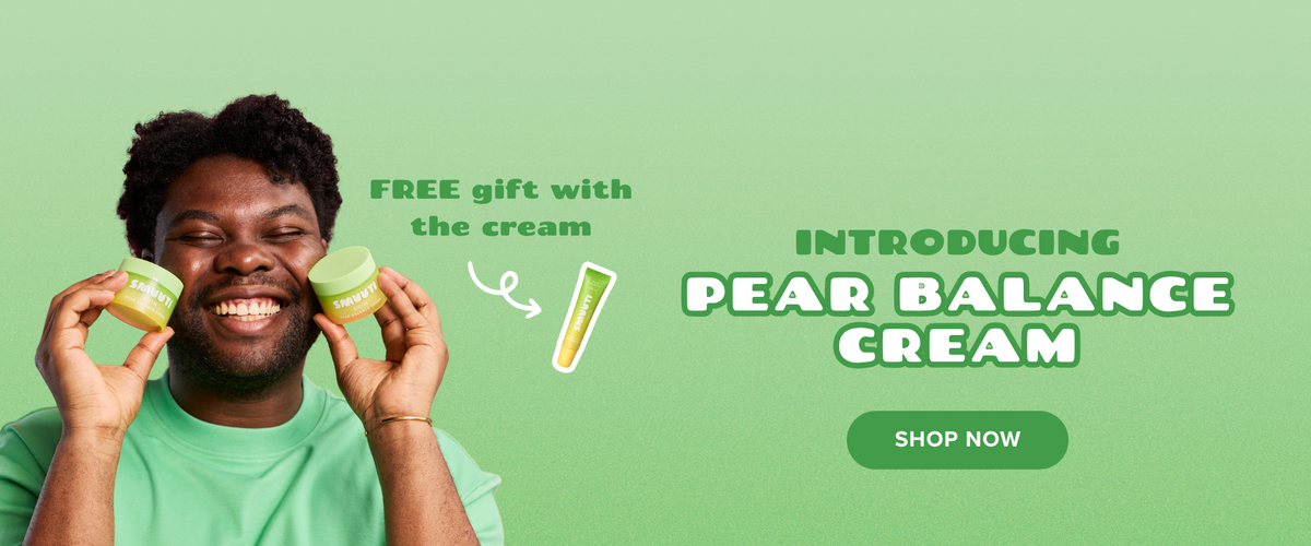 A promotional banner featuring a smiling man holding two green cream jars near his face against a light green background. Text on the right reads 'INTRODUCING PEAR BALANCE CREAM' with a green 'SHOP NOW' button, and additional text says 'FREE gift with the cream' with a small tube illustration.