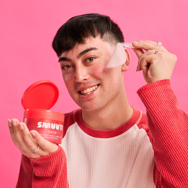A man with a new Strawberry Boost Toner Pads.