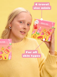 Person holding a Smuuti Skin mini kit with text "4 travel size minis, for all skin types"on a yellow background