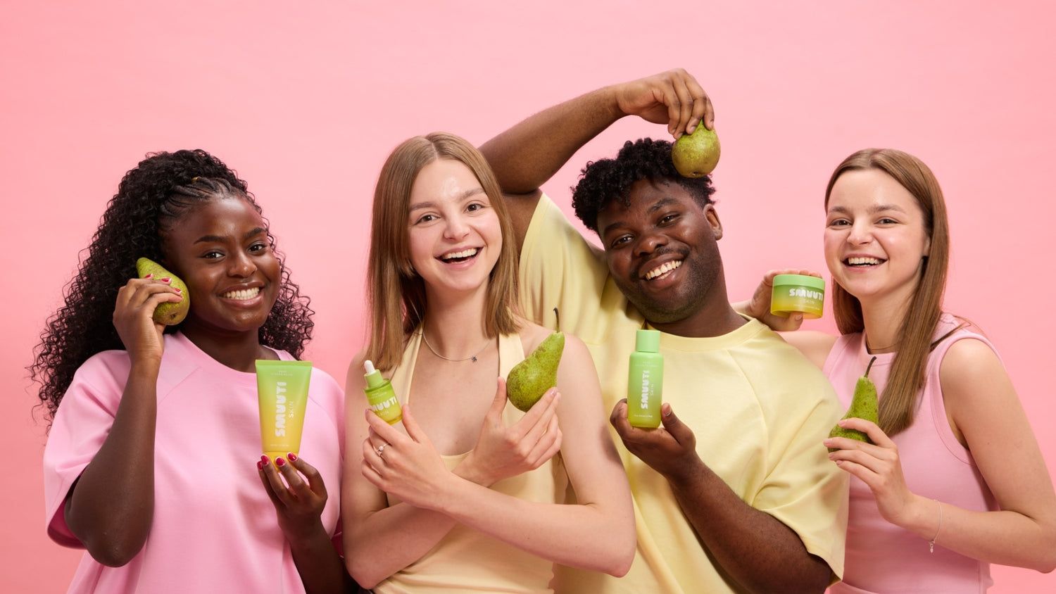 Four people holding Smuuti Skin pear balance products and pears against a pink background