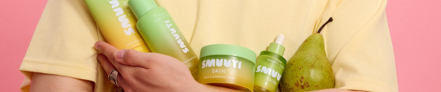 Person holding Smuuti Skin pear balance skincare products with a pink background
