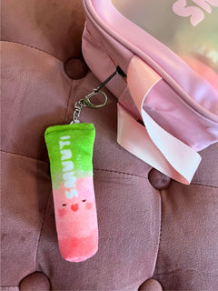 Colorful Smuuti Skin keychain with a gradient design on a pink surface