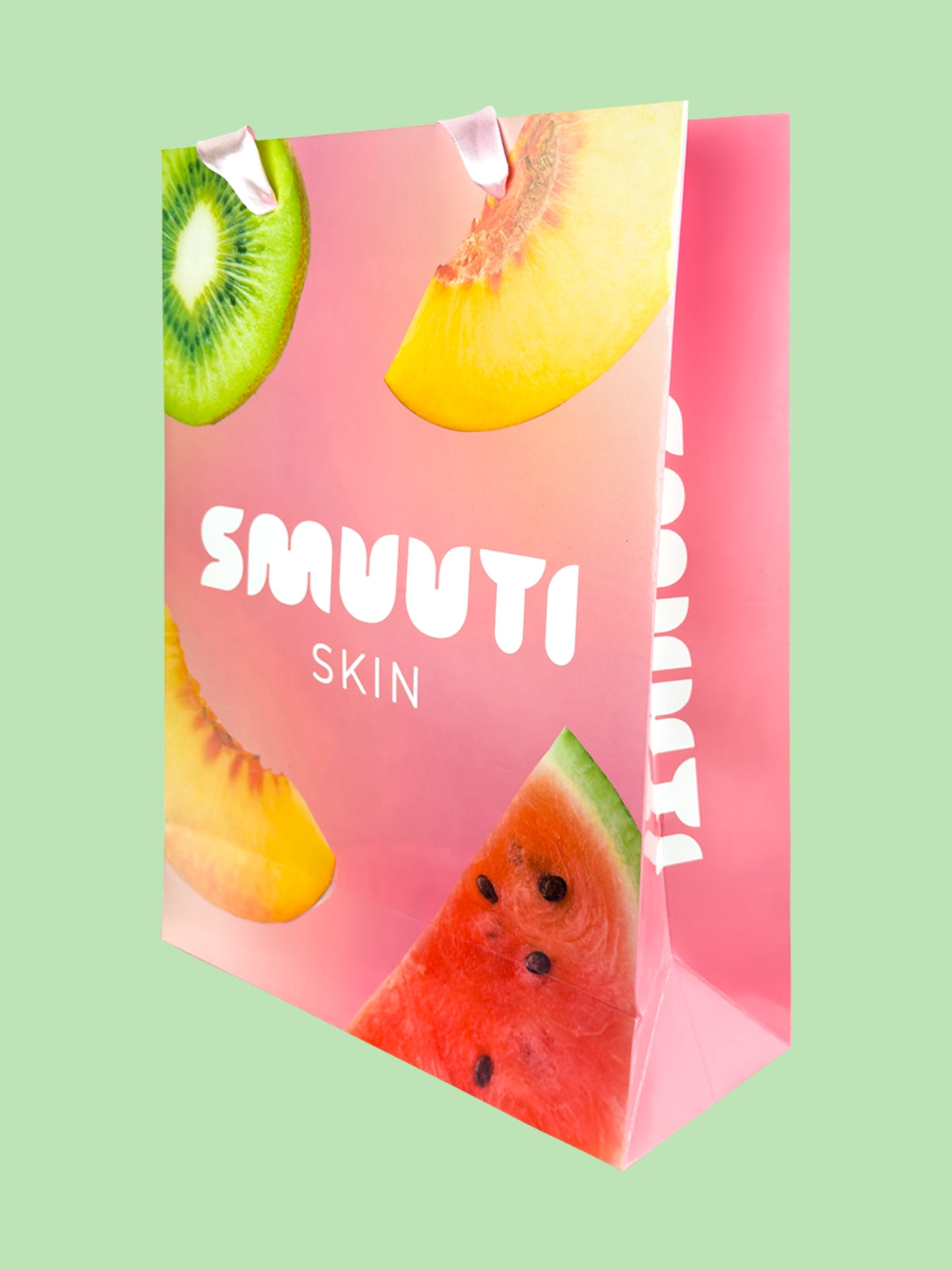 SMUUTI SKIN gift bag with a design of fruit slices on a pink background
