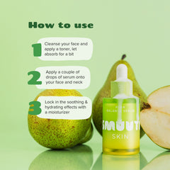 Bottle of smuuti skin pear balance serum with pears on a green background, showing usage instructions.