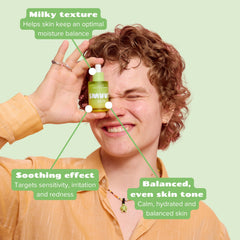 Person holding smuuti skin pear balance serum with text highlighting benefits on a light green background