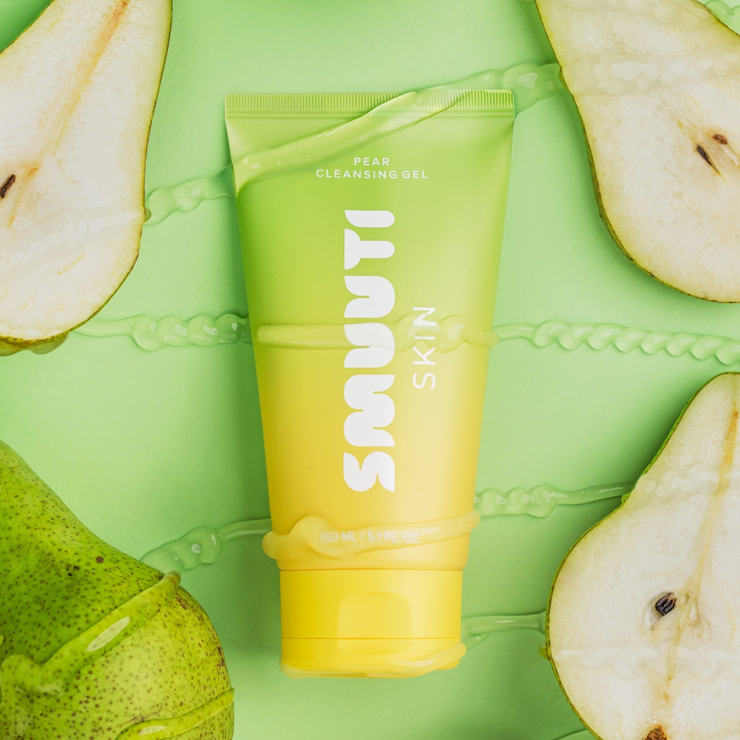Tube of smuuti skin pear cleansing gel surrounded by sliced pears on a green background