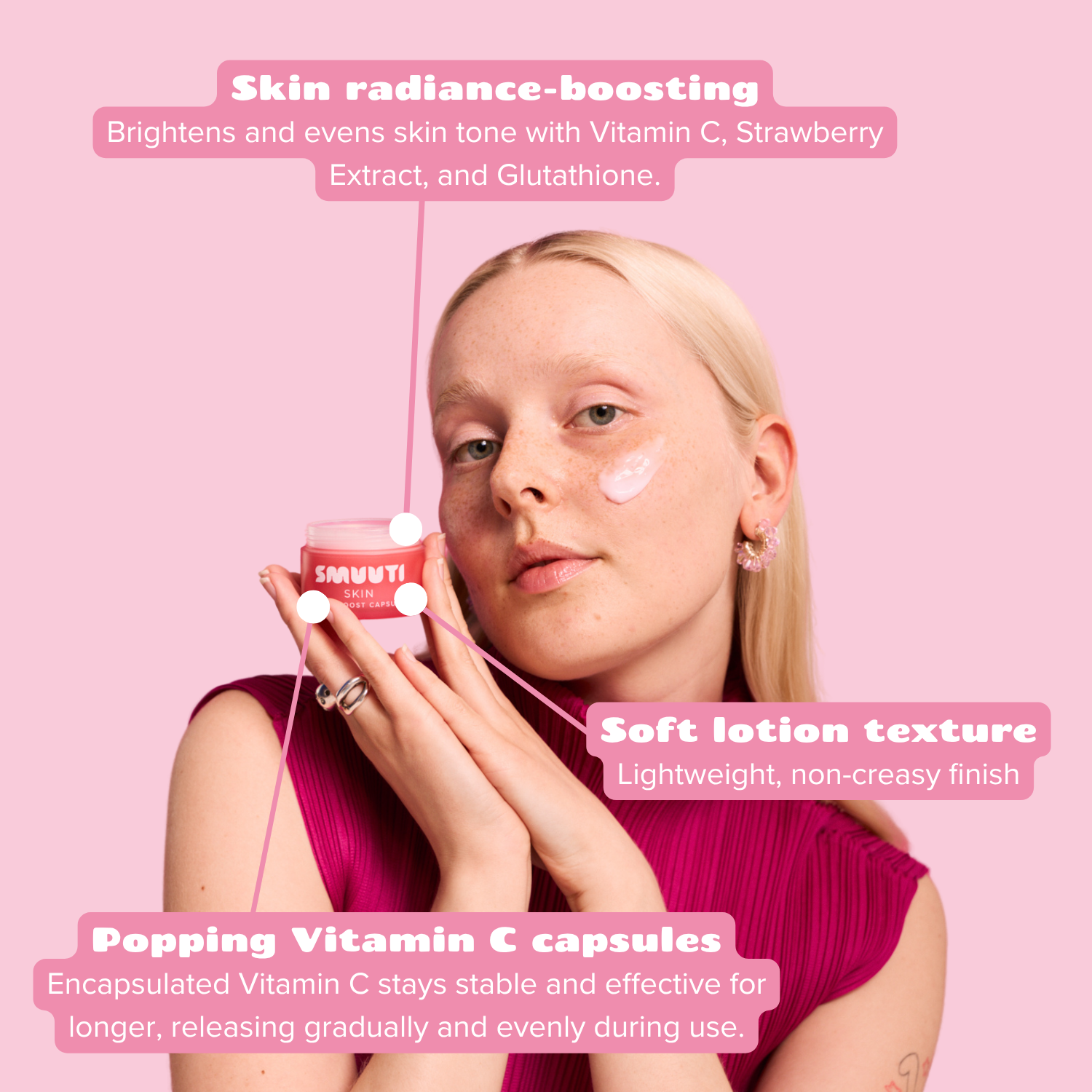 A woman with blonde hair holds the strawberry boost capsule cream against a solid pink background, with text callouts describing its skin radiance-boosting, soft lotion texture, and popping Vitamin C capsule features.